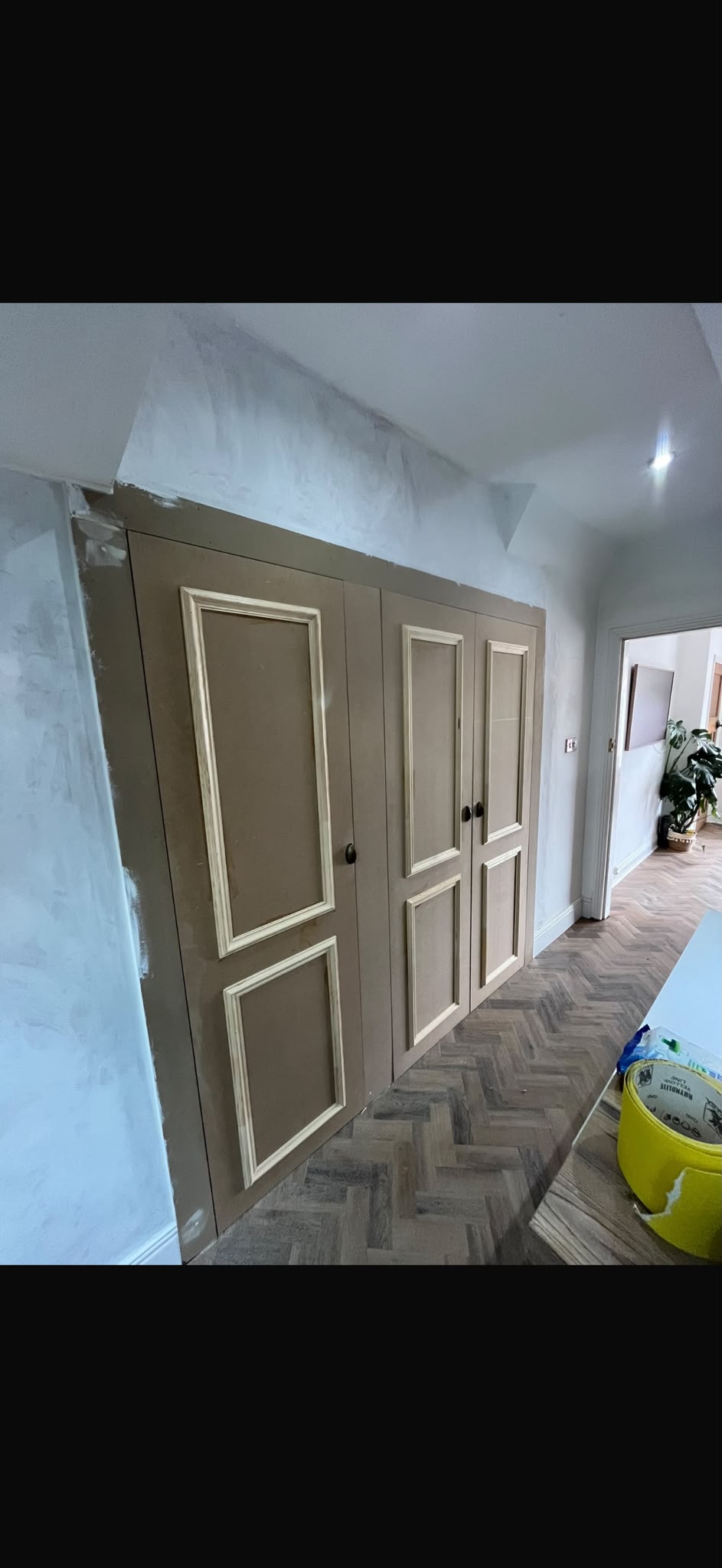 Fitted cupboards with decorative mouldings, photographed before final decoration.