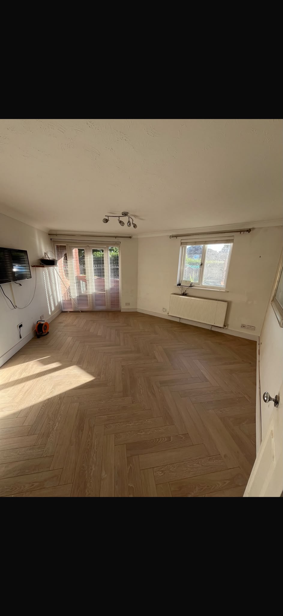 A herringbone floor bringing warmth and pattern to a living space.