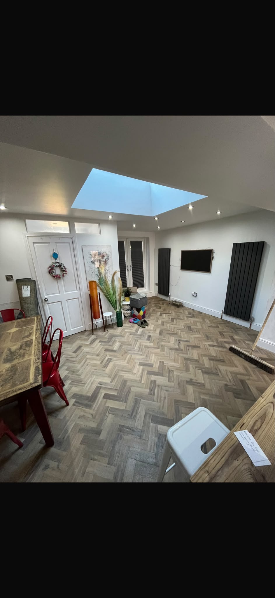An interior with a rooflight and patterned flooring.