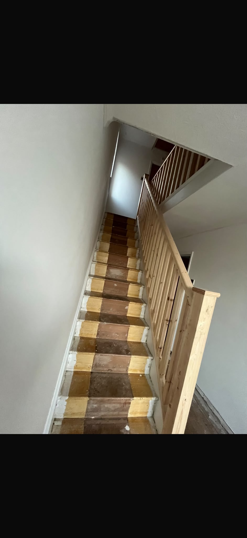 Timber handrail and spindles during a staircase refurbishment, before final decoration.