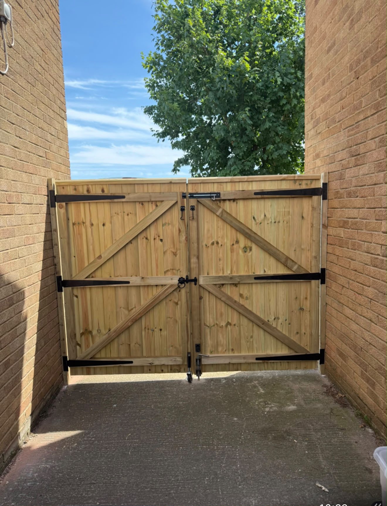Double timber gates with black ironmongery.